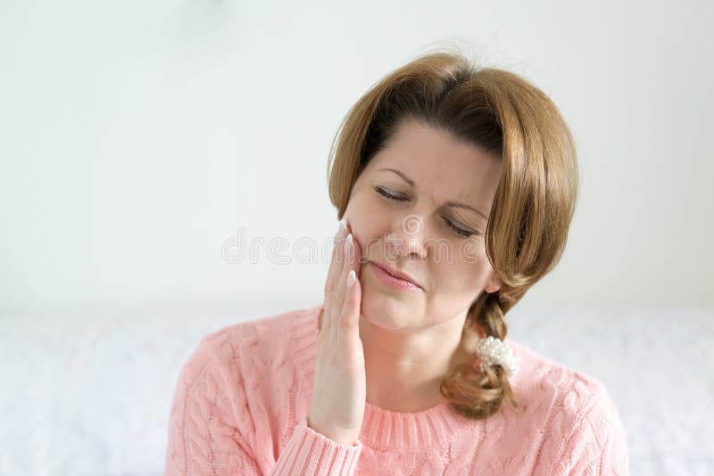 Young woman in pain is having toothache