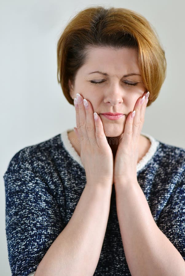 Young woman in pain is having a toothache