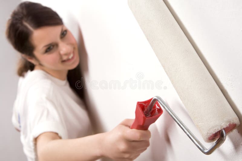 Young woman with painting roller