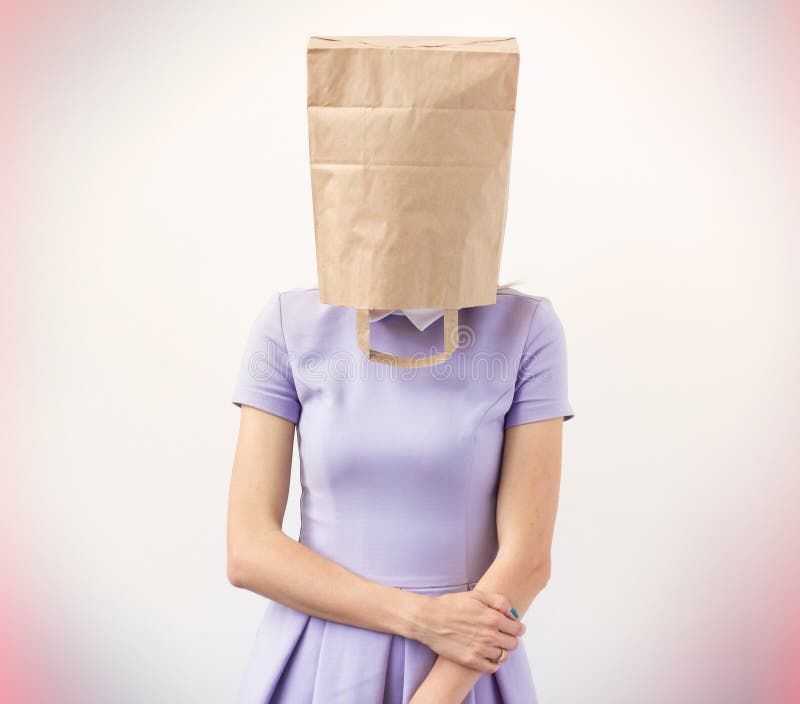 Young woman with empty paper bag over her head stock photography.