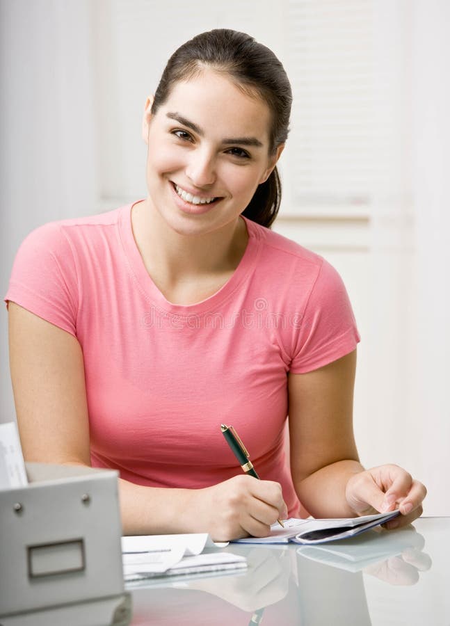 Young woman paying bills