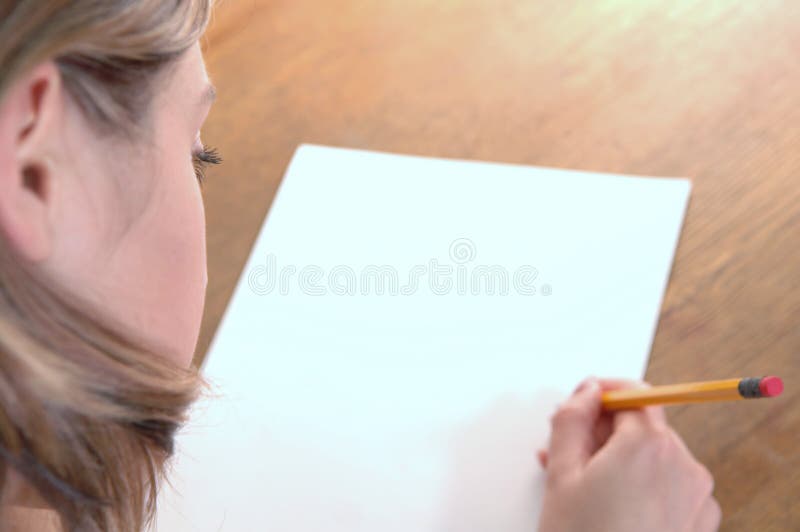 Young woman with pencil writing on paper