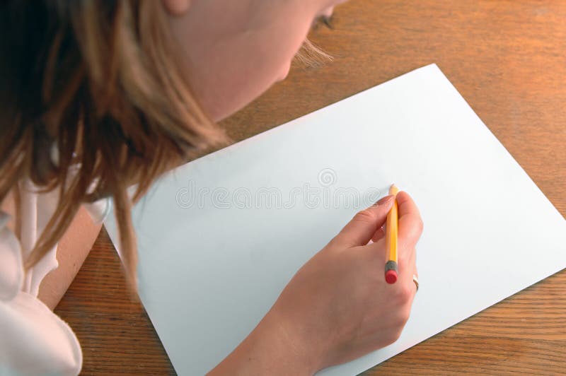 Young woman with pencil writing on paper