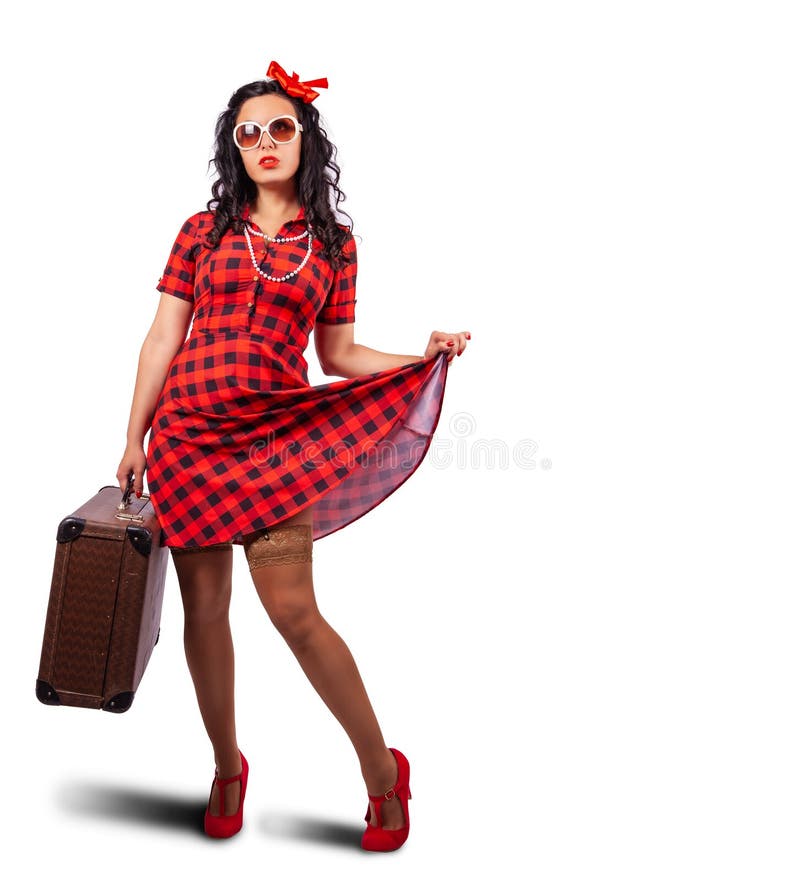 Young woman pin-up style posing standing with suitcase