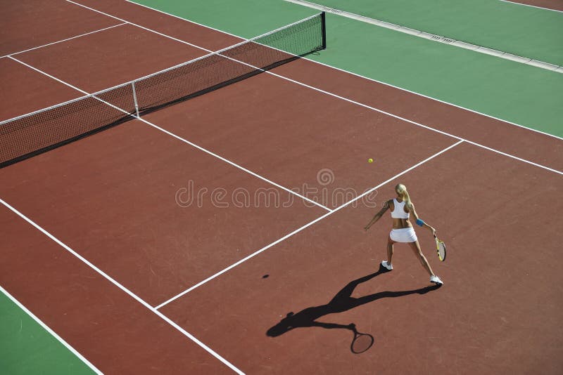 Young woman play tennis outdoor