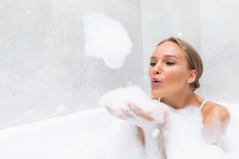 Young lass having fun in the bath