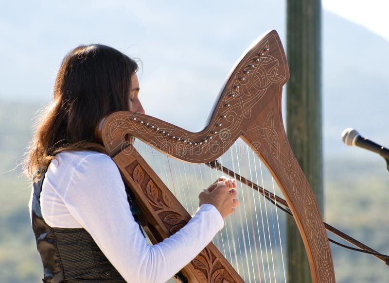 Woman playing the harp Stock Photo by ©halfpoint 51620443