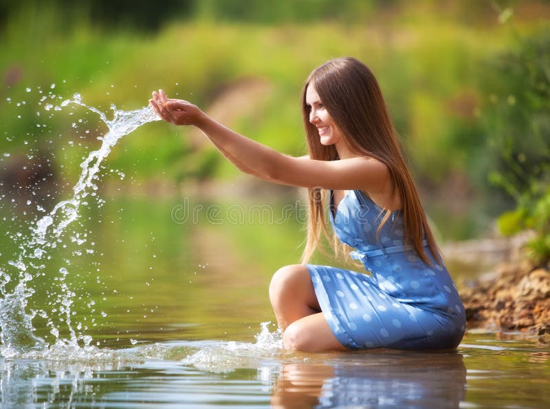 Young woman playing with water.