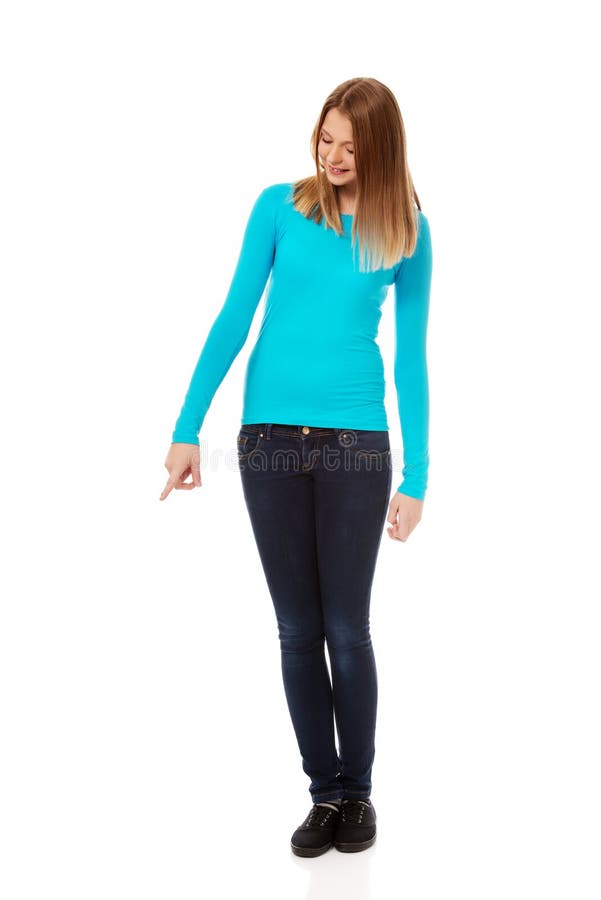 Young woman pointing down stock image. Image of teenage - 73857209