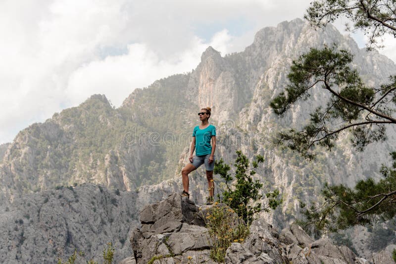 Young woman poses on top of the mountain stock photo Young woman poses on top of the mountain stock photo