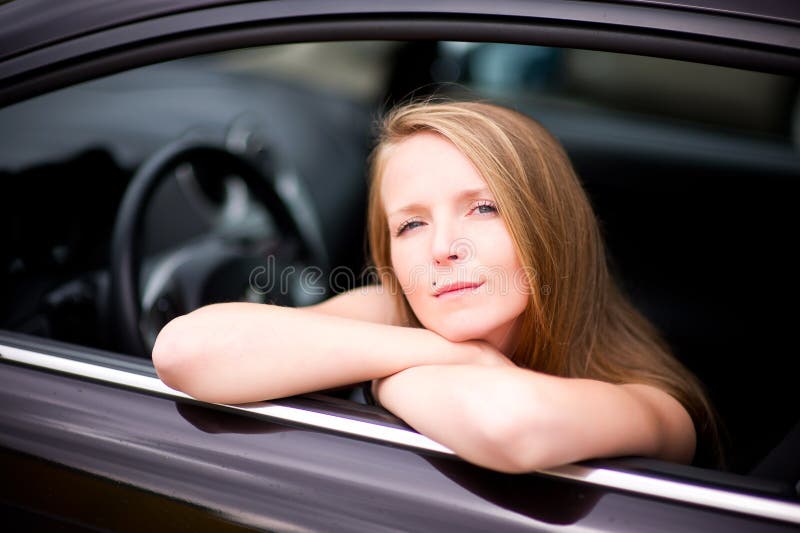 Close-up Of A Young Woman Looking Through A Car Window In A Traffic Jam ...