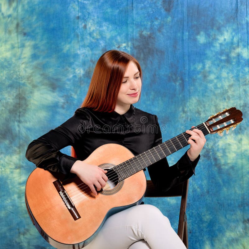 Young Woman Posing in the Studio Holding a Classical Guitar Stock Photo -  Image of redhead, attractive: 71423664