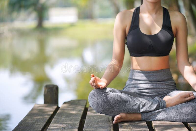 Young woman practicing yoga in the nature, Female happiness, Asian woman is practicing yoga at mountain lake stock image Young woman practicing yoga in the nature, Female happiness, Asian woman is practicing yoga at mountain lake stock image