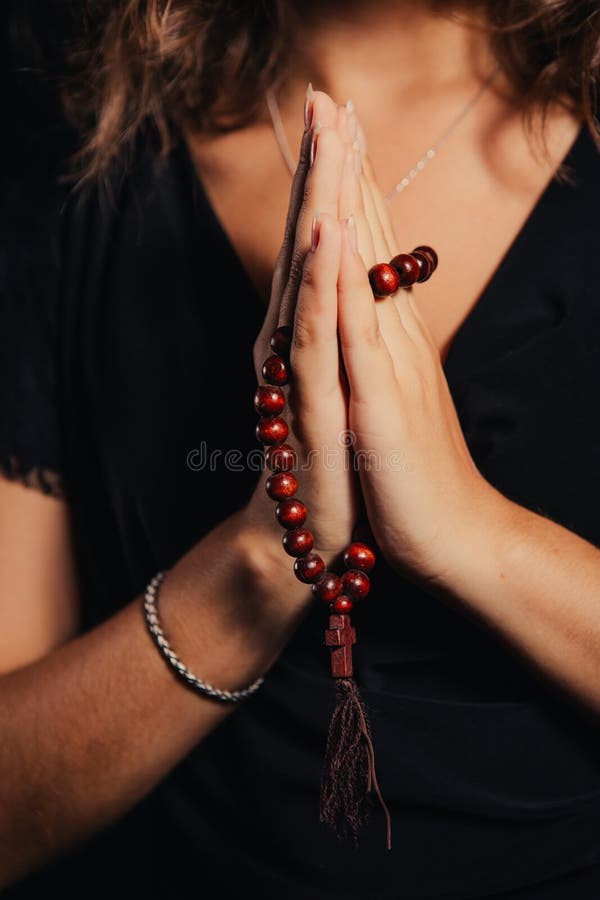 Young Woman Praying with Rosary in Hand Stock Photo - Image of black