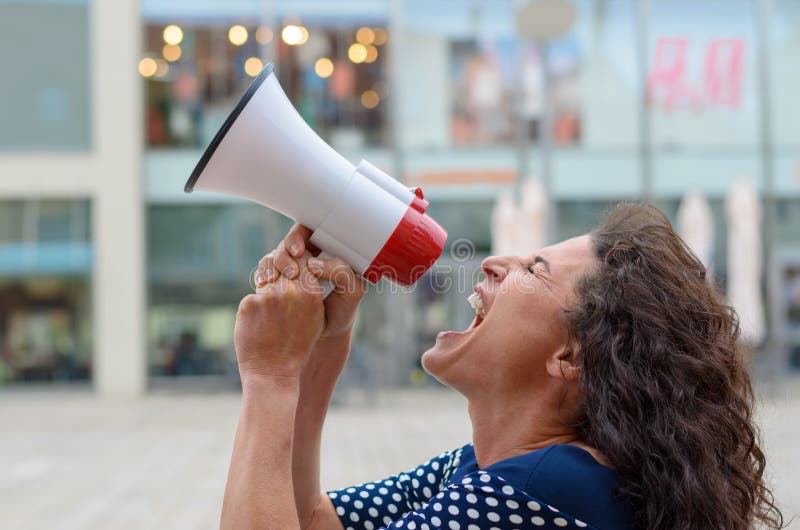 Young woman protester shouting into a megaphone royalty free stock photography Young woman protester shouting into a megaphone royalty free stock photography