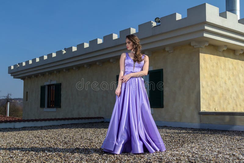 Download A Girl With A Gun Standing On A Rooftop