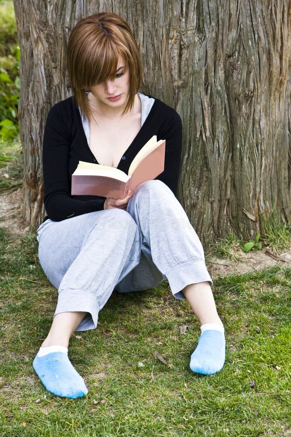 Young woman reading in the park