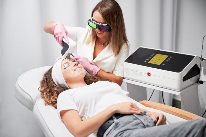 Young Woman Receiving Laser Facial Treatment In Cosmetology Clinic Stock Image Image Of Care