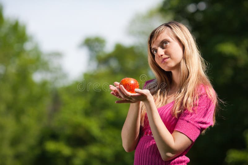 Young woman with a red apple