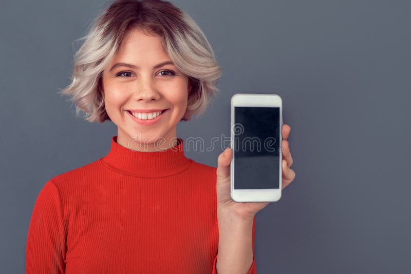 Young woman in a red blouse on grey wall smartphone screen