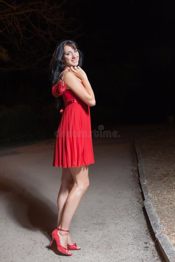 Young Woman in Red Sleeveless Dress Walking in Night Park Stock Image ...