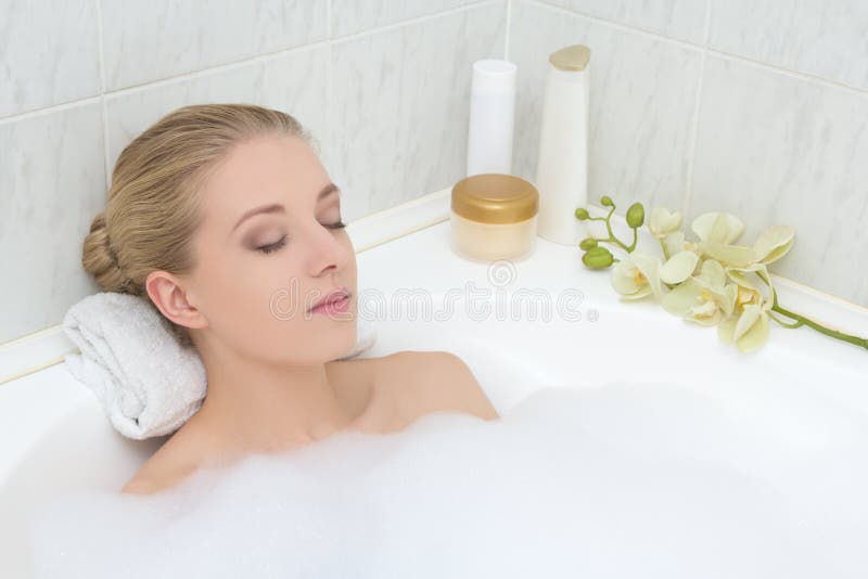 Young woman relaxing in bath with foam stock image Young woman relaxing in bath with foam stock image