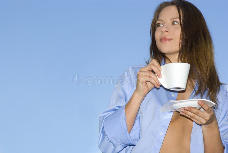 Young woman relaxing, drinking coffee