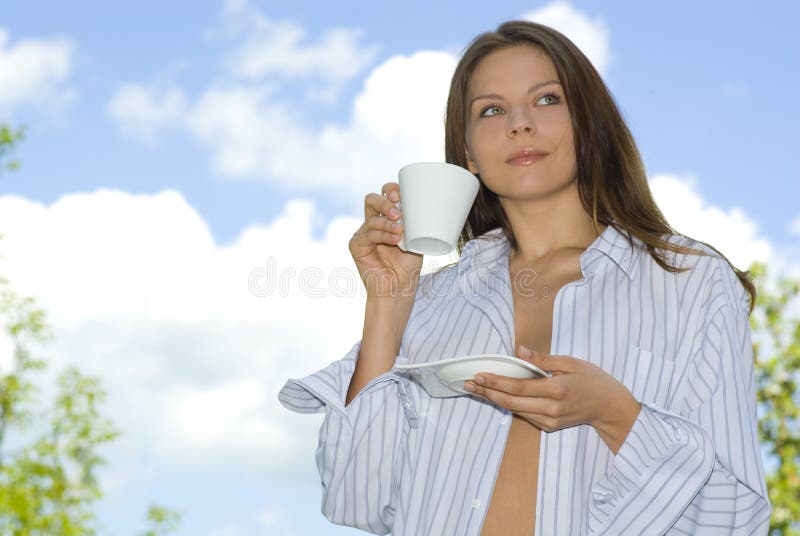 Young woman relaxing, drinking coffee