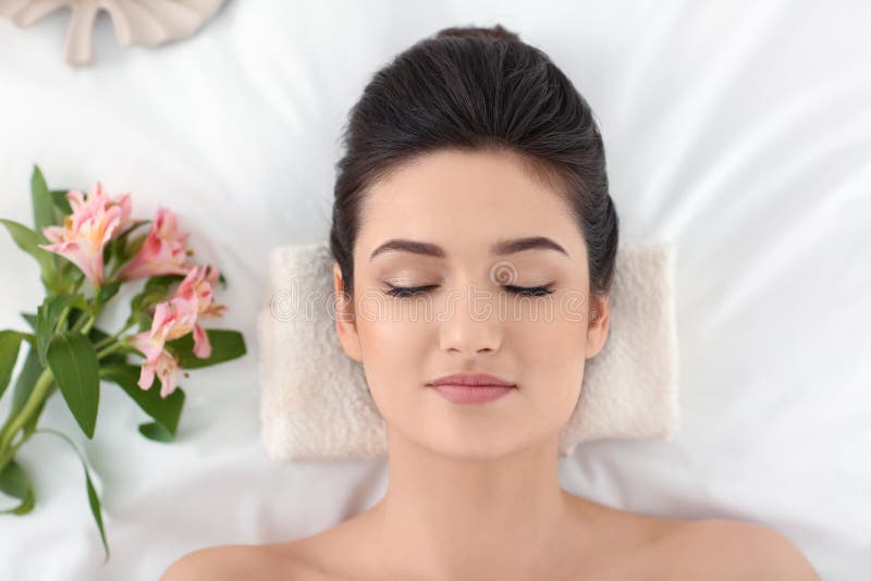 Young Woman Relaxing On Massage Table At Spa Salon Top View Stock