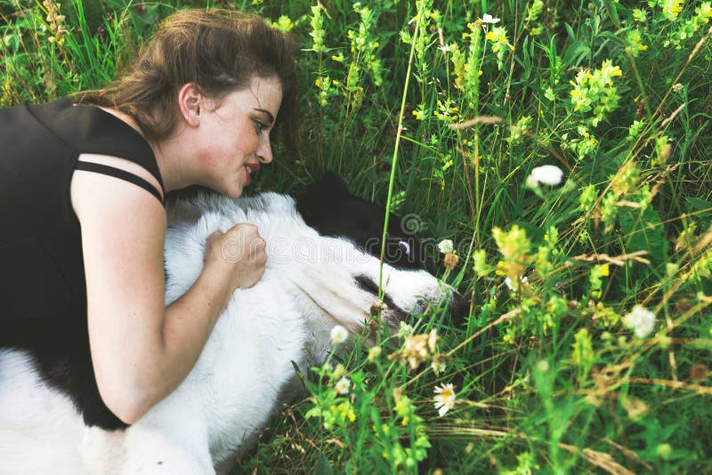 Download Young Woman Resting With Central Asian Shepherd Dog Stock Image - Image of maple, green: 74306787