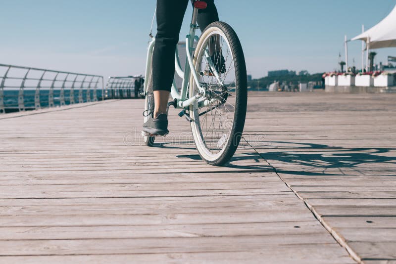 Young Woman Riding Bike on the Waterfront Near the Sea Stock Photo ...