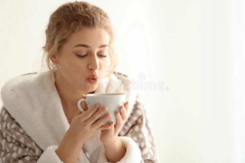 Young Woman in Robe Drinking Tea on Light Background Stock Image ...