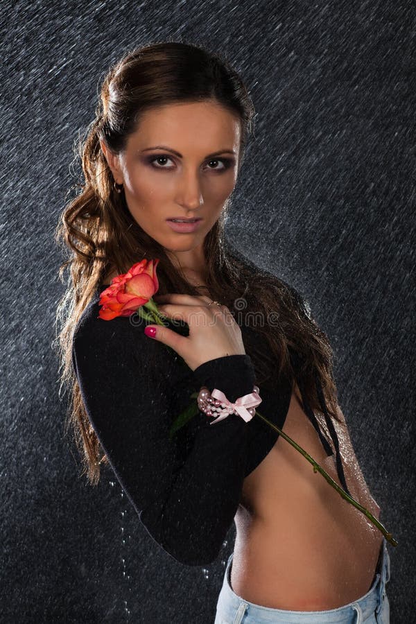 Young woman with rose under rain. royalty free stock photos