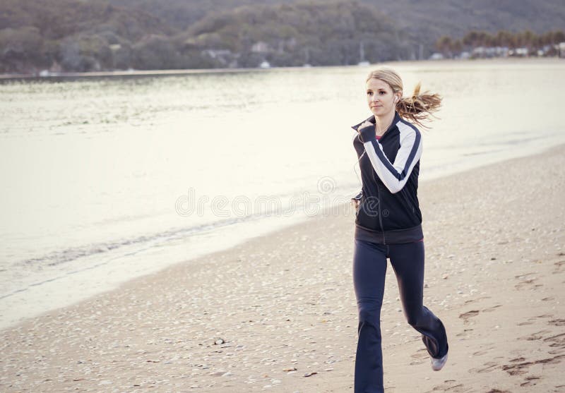 Young Woman running along the beach stock photos Young Woman running along the beach stock photos