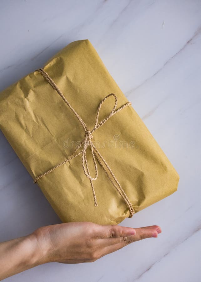 Young woman& x27;s hand is holding a post mail on white marble wall background stock photos Young woman& x27;s hand is holding a post mail on white marble wall background stock photos
