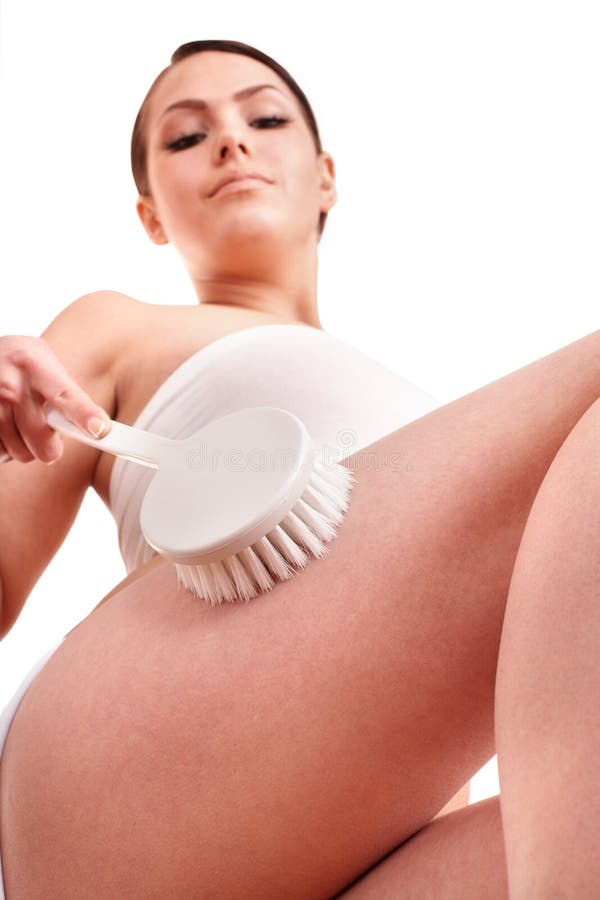 Young woman scrubbing body. stock photos