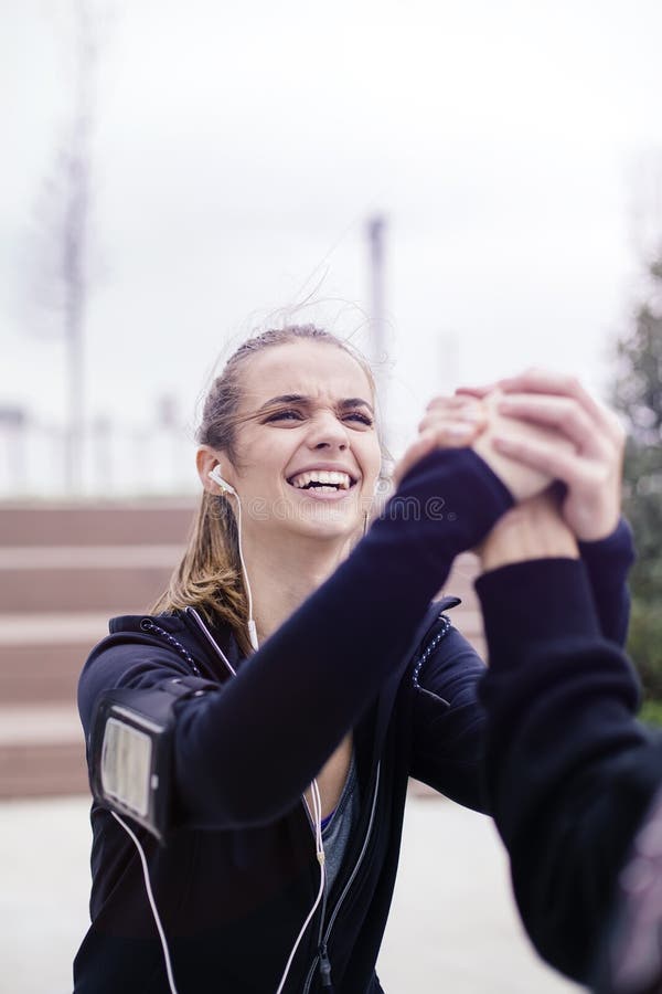 Young Woman is Shaking the Arm of Her Personal Trainer Stock Image