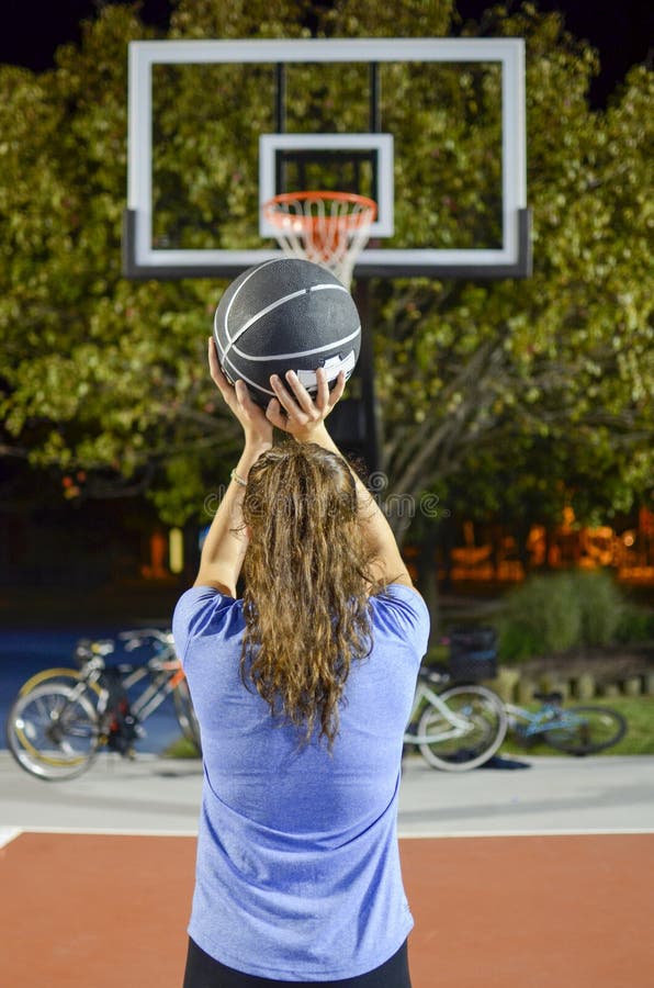 Young woman shooting at the basket