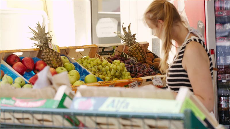 Young woman shopping for fresh fruit