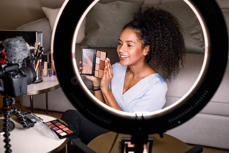 Young woman showing a makeup palette