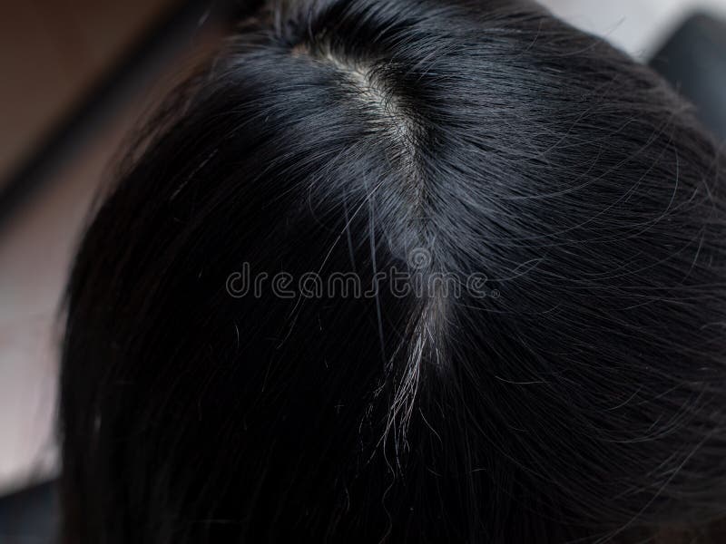 Young woman shows her white hair roots stock images