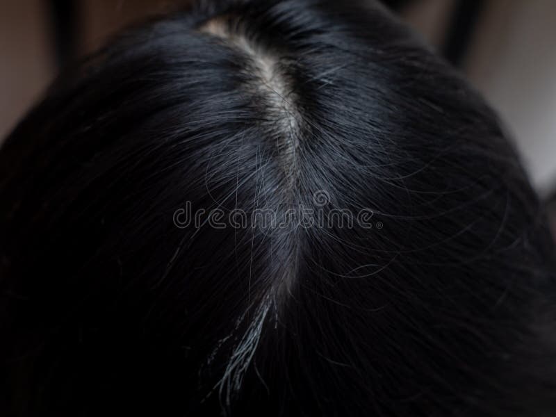 Young woman shows her white hair roots royalty free stock image
