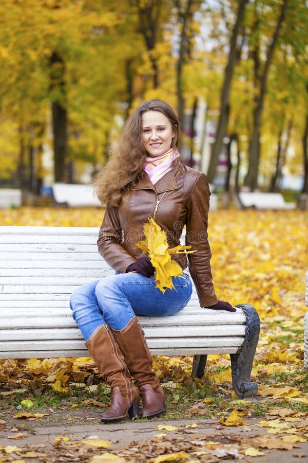 Young Woman Sitting on Bench in the Autumn Park Stock Image - Image of ...