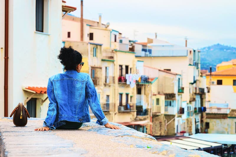 Premium Photo  Seductive sicilian woman sitting on a step in an old town  in sicily