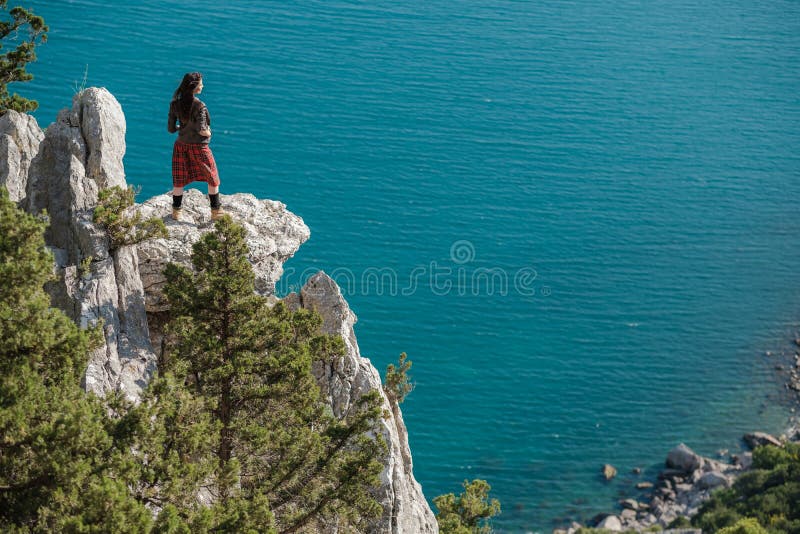 Young woman sitting on cliff and enjoy the view royalty free stock image Young woman sitting on cliff and enjoy the view royalty free stock image