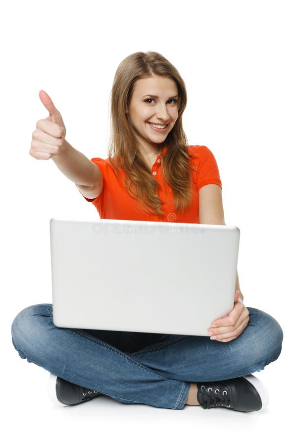 Woman sitting on the floor with her laptop making thumb up