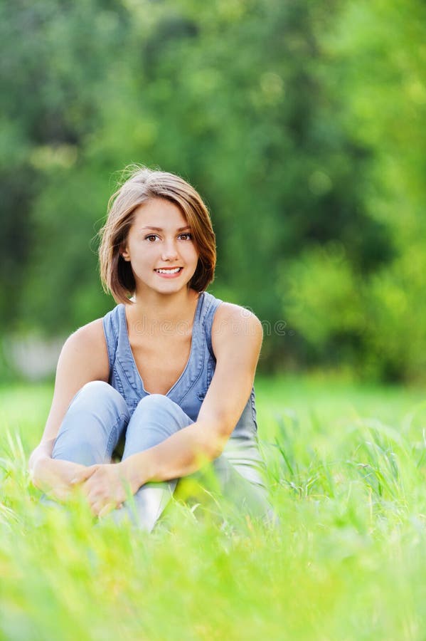 Young woman sitting grass