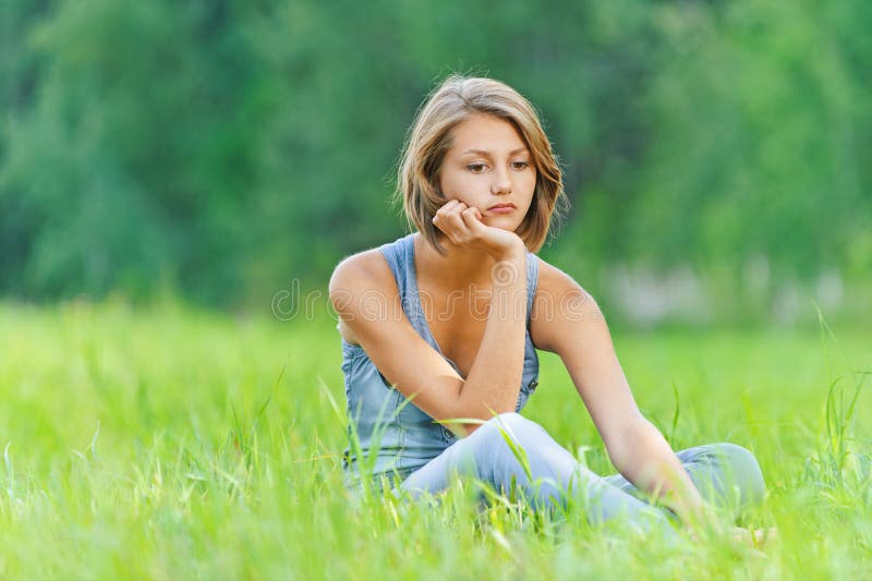 Young woman sitting grass