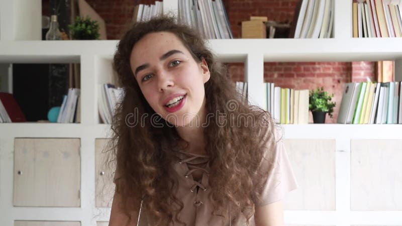 Young Woman Sitting Indoors Talks Via Webcam Looking at Camera Stock Footage - Video of conference, person: 154661782