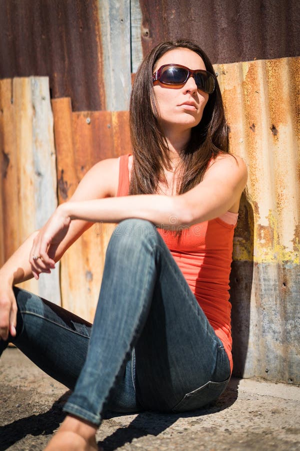 Woman Sitting Against Wall stock images Woman Sitting Against Wall stock images